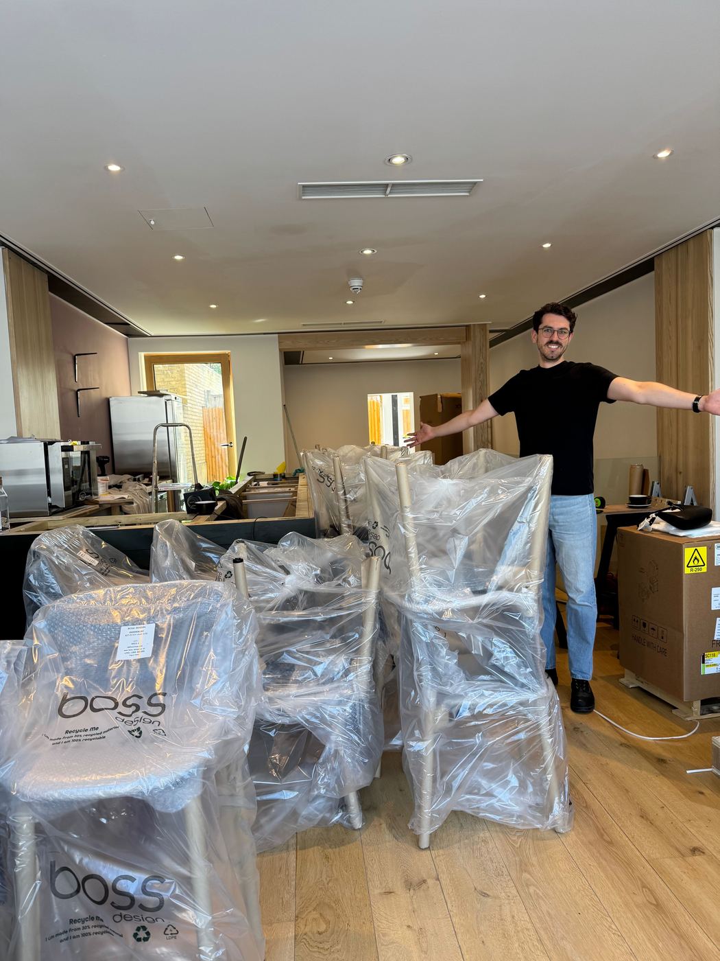Luke with a delivery of chairs still in their wrapping