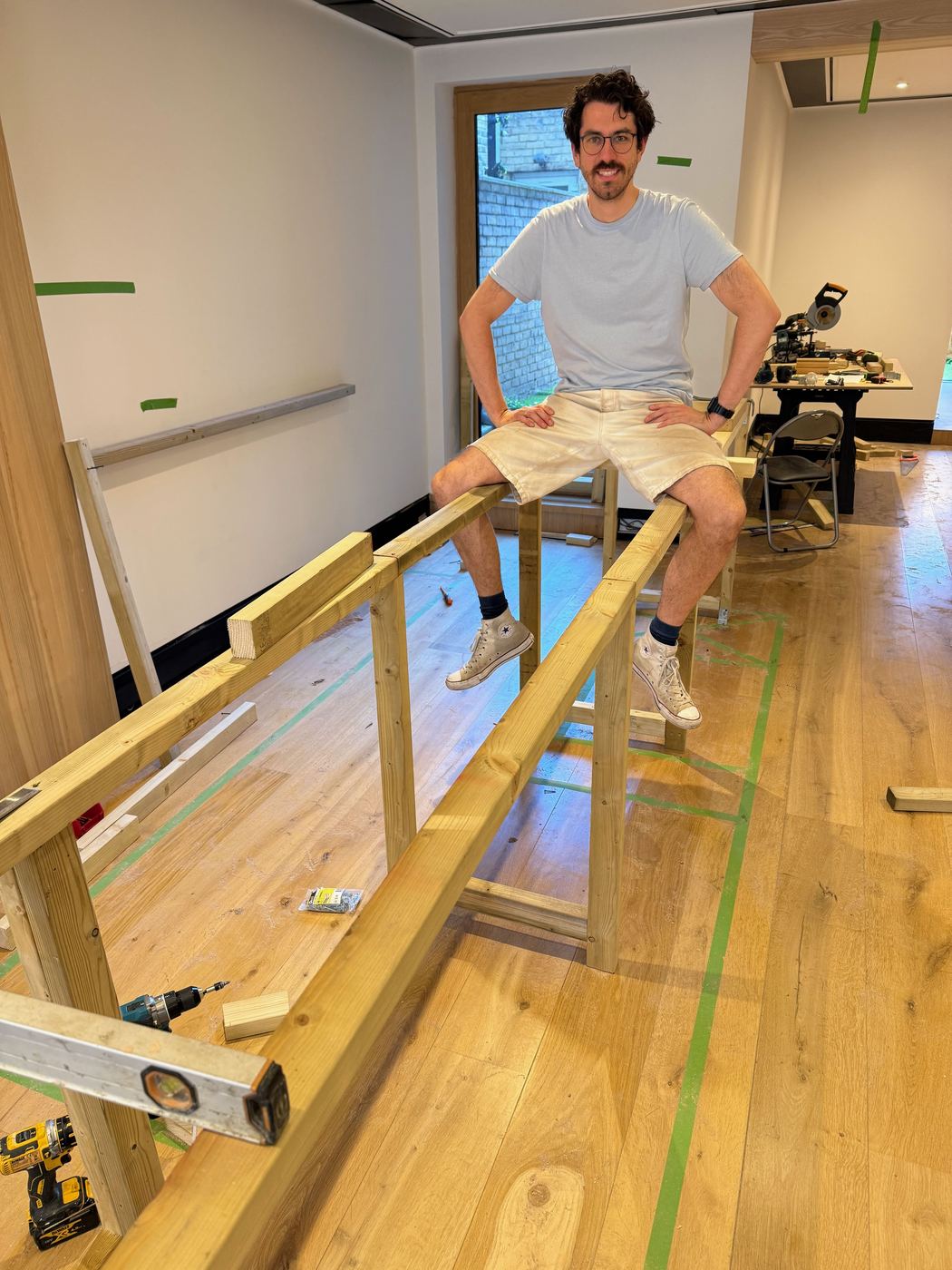 Luke on the coffee-bar frame during the build