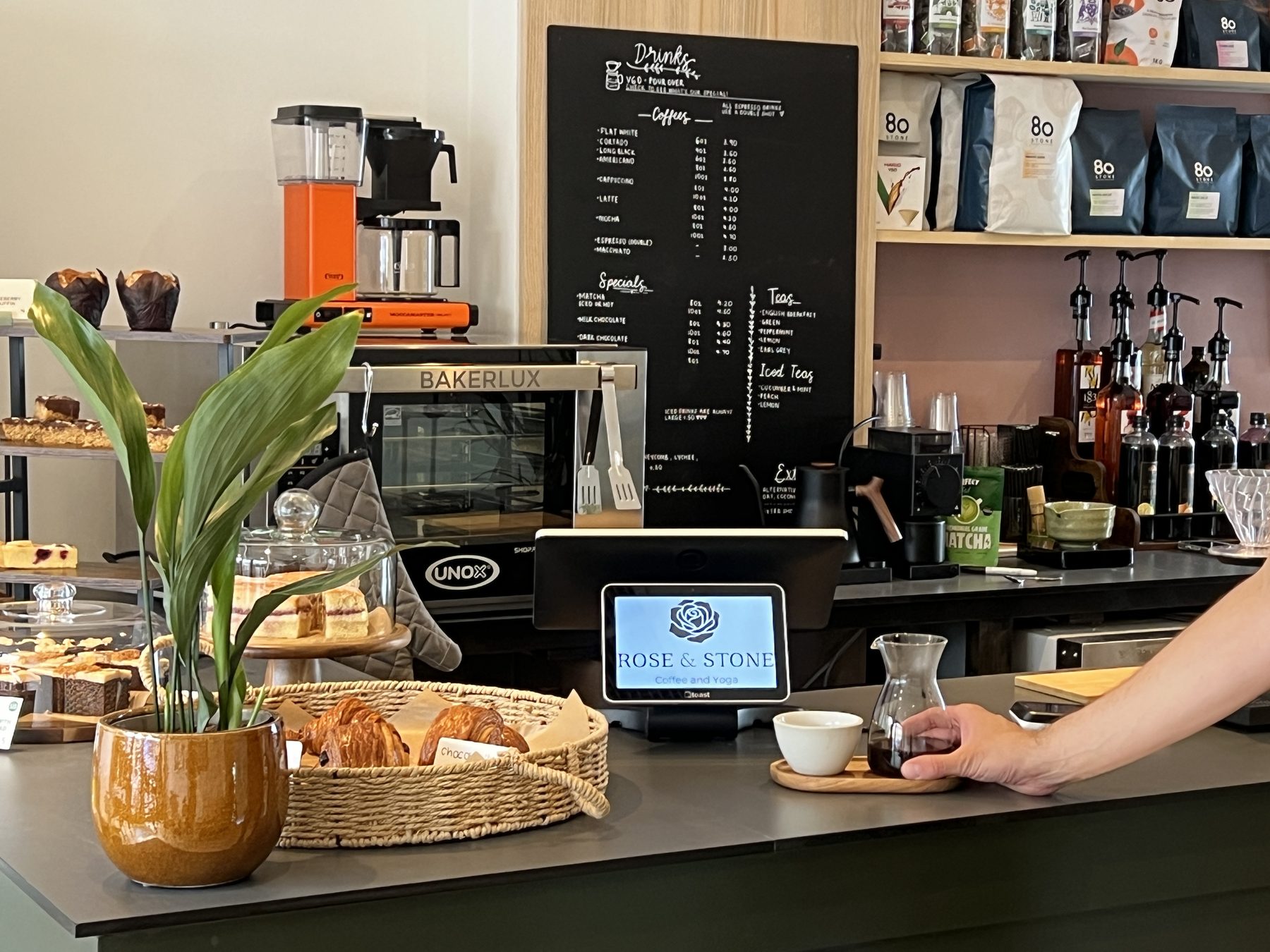 The coffee counter at Rose & Stone — croissants, cakes and the espresso machine