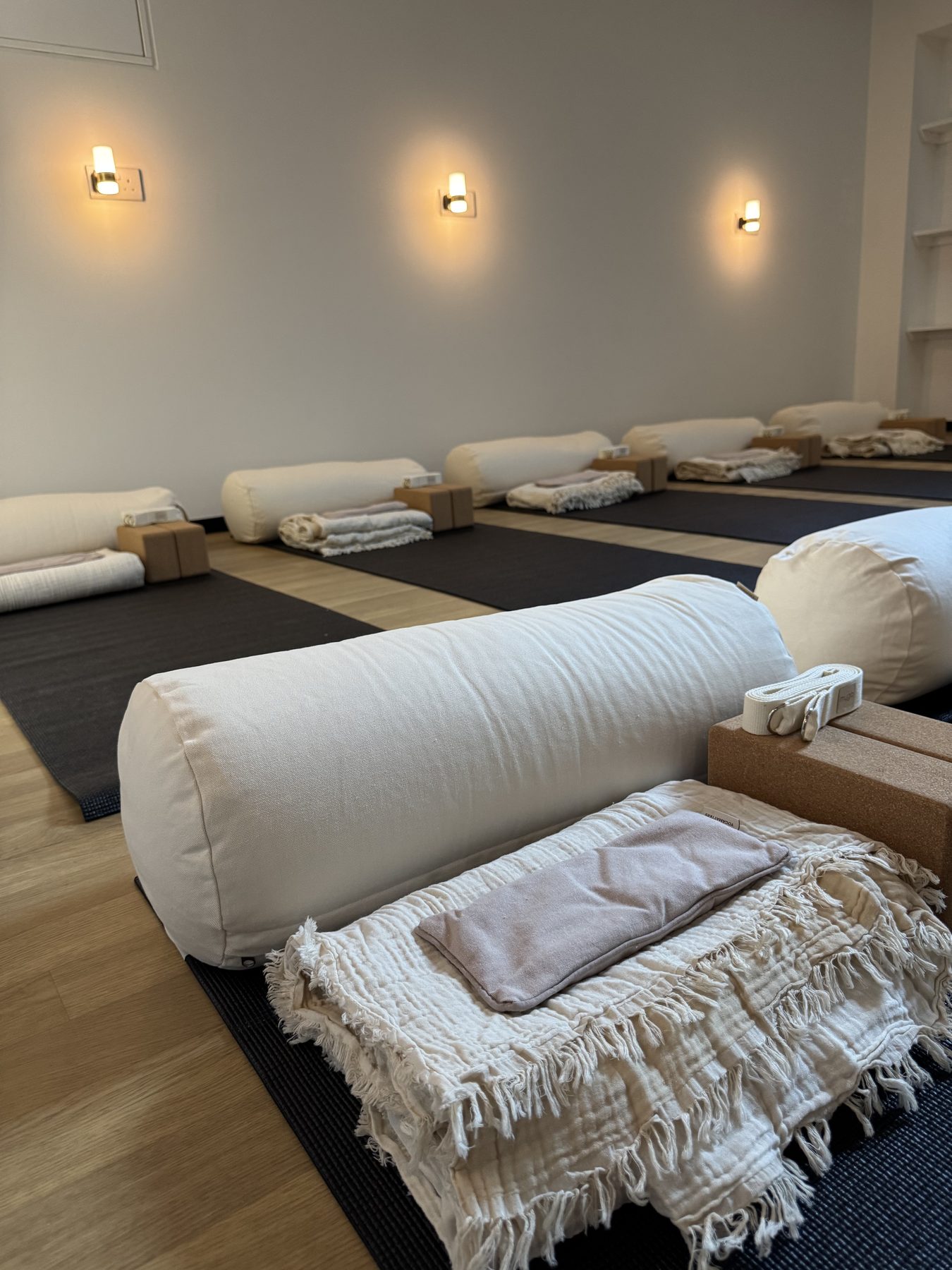 The yoga studio downstairs at Rose & Stone, set with mats, bolsters and blankets