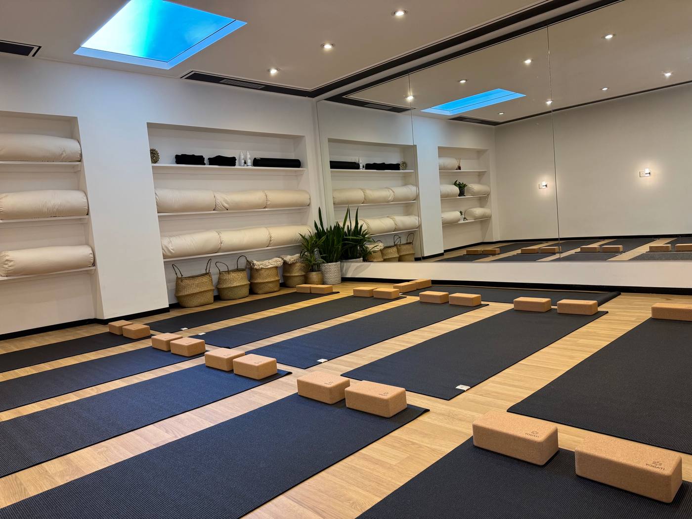 The yoga studio at Rose & Stone, East Hill — mats, cork blocks, and a skylight